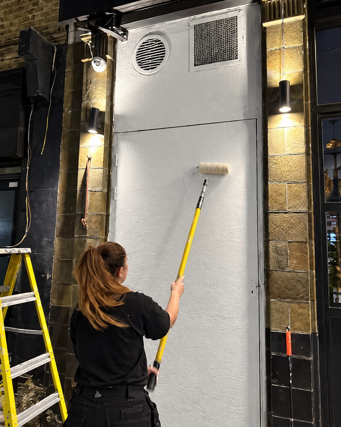 Rolling paint on an exterior wall