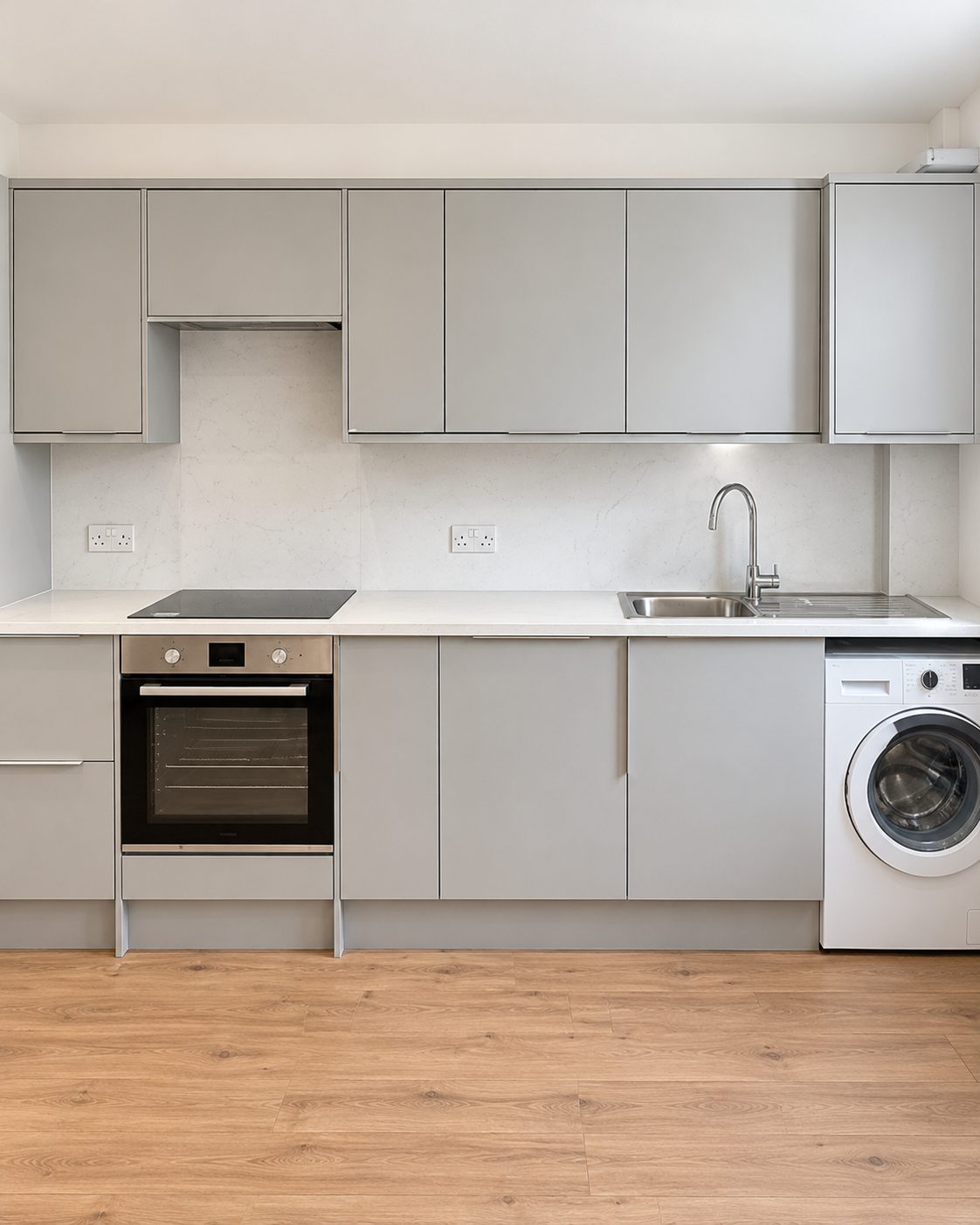 Grey handleless kitchen with oak floor